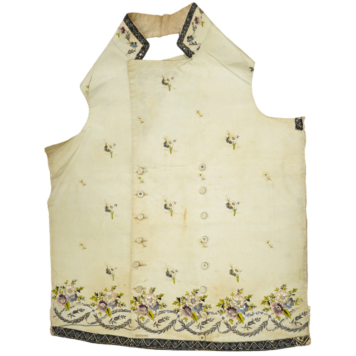 A late George III / George IV gentleman’s cream silk embroidered and cut steel waistcoat front, finely embroidered with polychrome flowers and cut steel appliqués on wide lapels, panel fronts and stand up collar, edged w